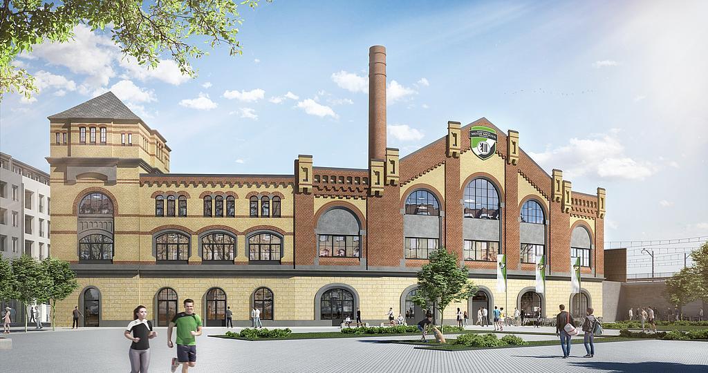 Historisches Fabrikgeb&auml;ude mit roten Ziegeln und gro&szlig;en Fensterfronten, umgeben von gr&uuml;nen B&auml;umen und Spazierg&auml;ngern.